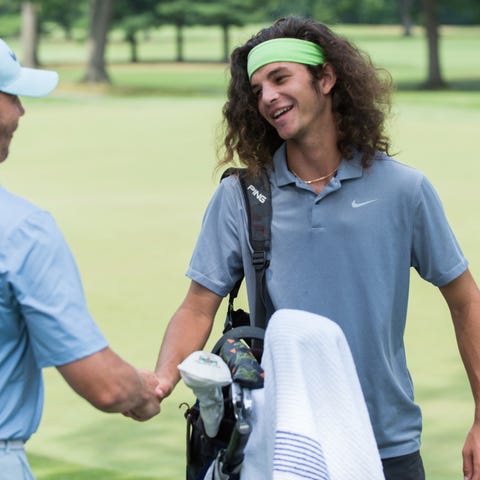 Jake Beber-Frankel shakes hands with a spectator...