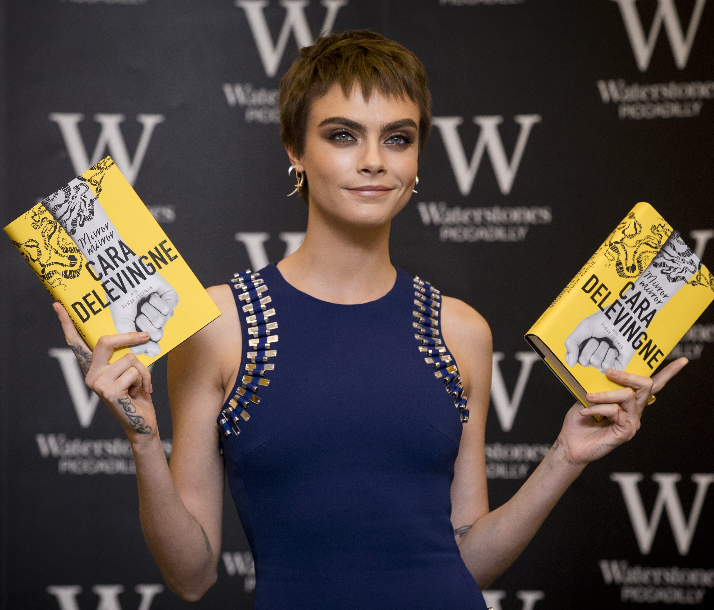 Cara Delevingne attends the signing of her debut novel 'Mirror, Mirror' on Oct. 4, 2017 in London.