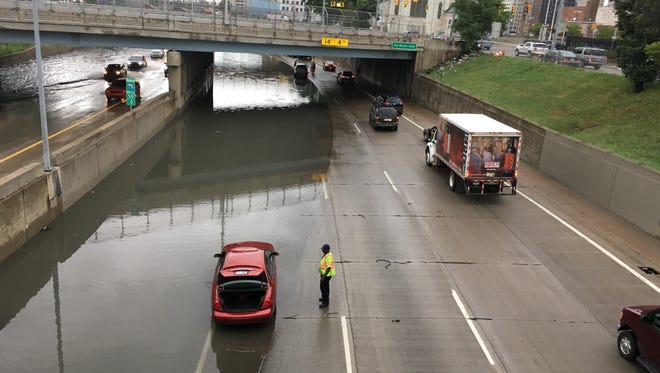 Motorists struggle through a flooded I-75 at Grand River on Tuesday, Aug. 16, 2016 in downtown Detroit.