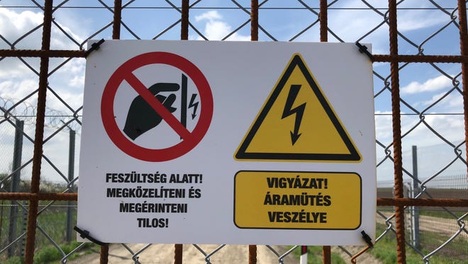 An electrified fence with a "do not touch" warning on Hungary's border with Serbia and Romania, on April 13, 2018.