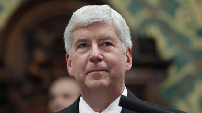 FILE - In this Jan. 23, 2018, file photo, former Michigan Gov. Rick Snyder delivers his State of the State address at the state Capitol in Lansing, Mich. Former Gov. Snyder, Nick Lyon, former director of the Michigan Department of Health and Human Services, and other ex-officials have been told they're being charged after a new investigation of the Flint water scandal, which devastated the majority Black city with lead-contaminated water and was blamed for a deadly outbreak of Legionnaires' disease in 2014-15, The Associated Press has learned.