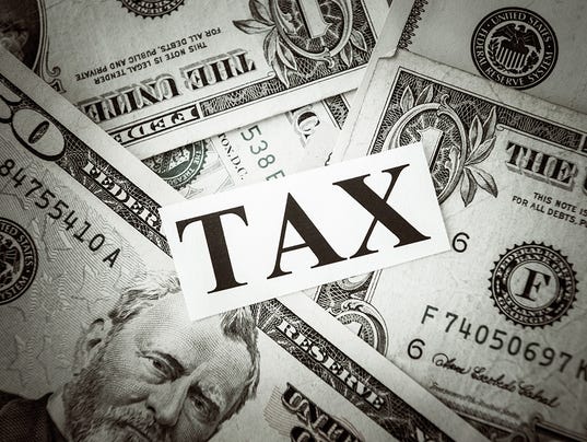 TAX text on a bunch of American dollars