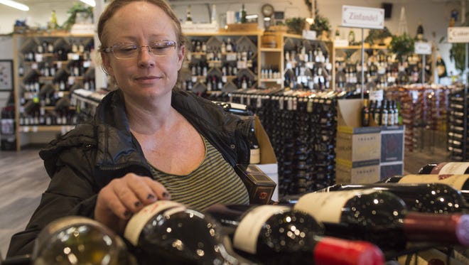 Erica Cowan shops for a bottle of wine at Pringle's on West Drake Road Wednesday, January 27, 2016. Your Choice Colorado aims to bring the idea of full-strength wine and beer to grocery stores around the state.