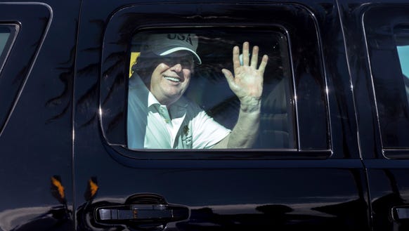 President Trump waves to supporters from his motorcade