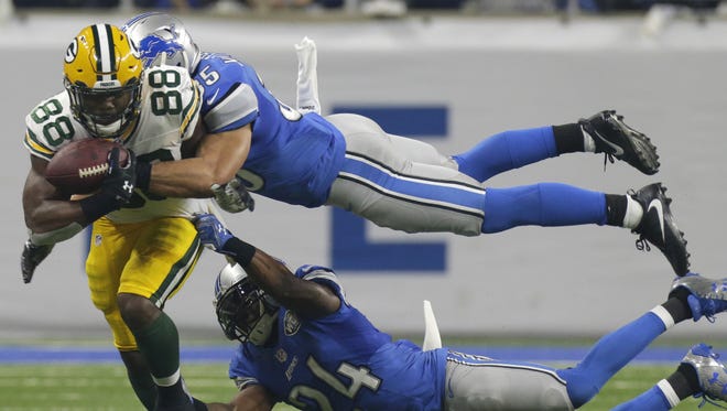 Green Bay Packers running back Ty Montgomery (88) is stopped short of a first down by Detroit Lions strong safety Miles Killebrew (35) and cornerback Nevin Lawson (24) during the third quarter on Jan. 1, 2017, at Ford Field in Detroit.