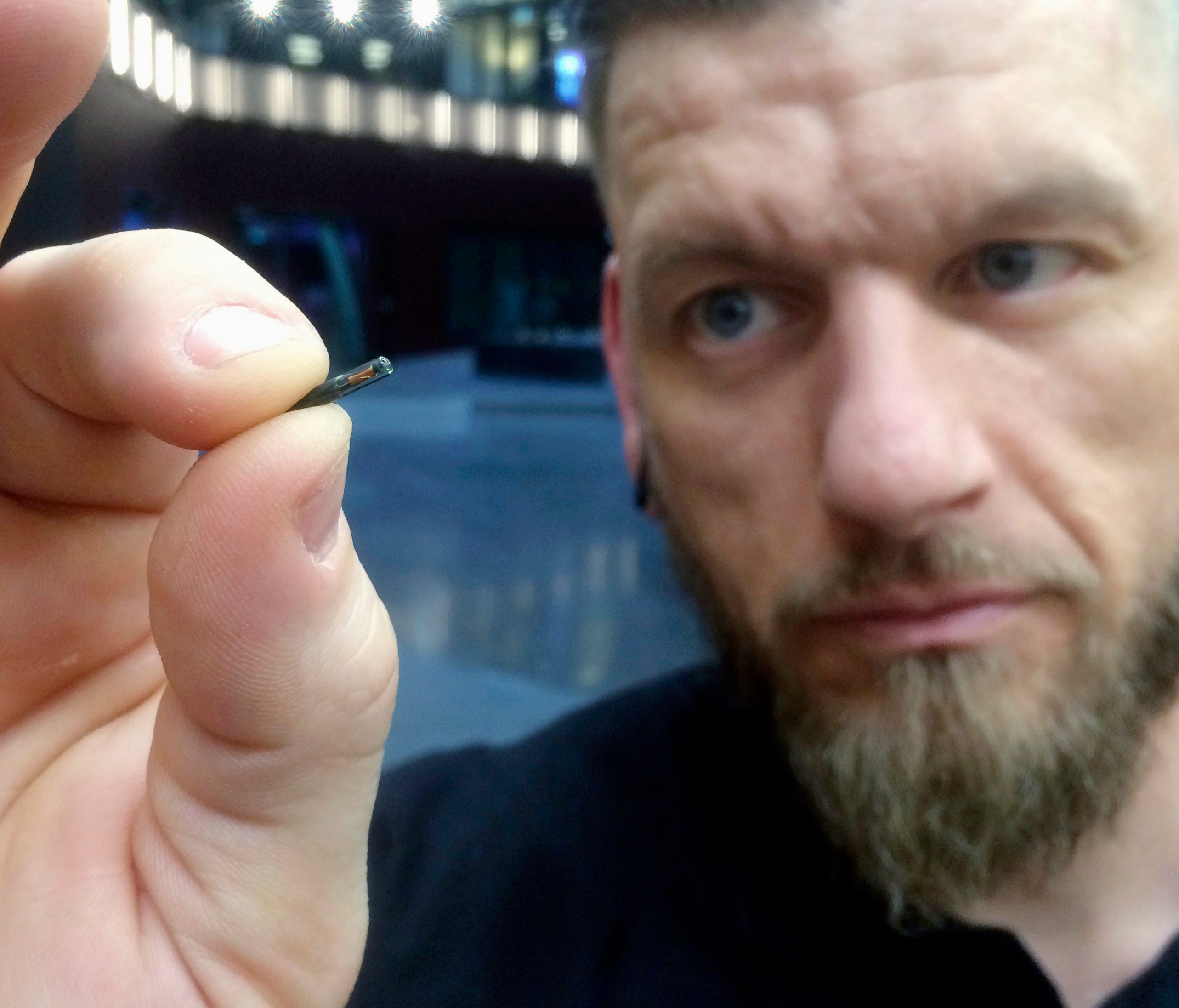 Jowan Osterlund from Biohax Sweden, holds a small microchip implant, similar to those implanted into workers at the Epicenter digital innovation business center