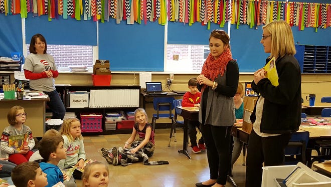 Jessica Beaven, left, and Laura Elder speak to one of the classes the Rotary Club of Union County provided books for.