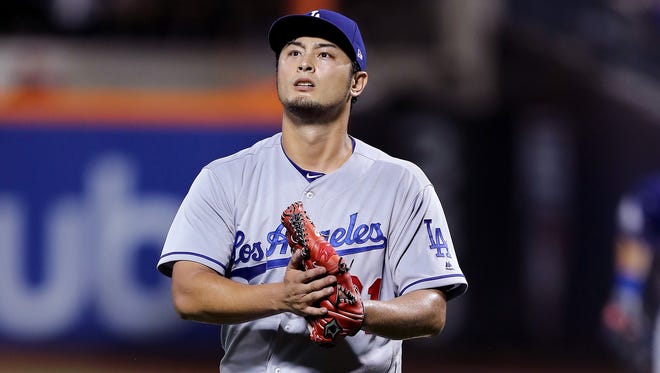 Yu Darvish  celebrates the last out of the seventh inning against the  Mets in his debut with the Dodgers on Friday.