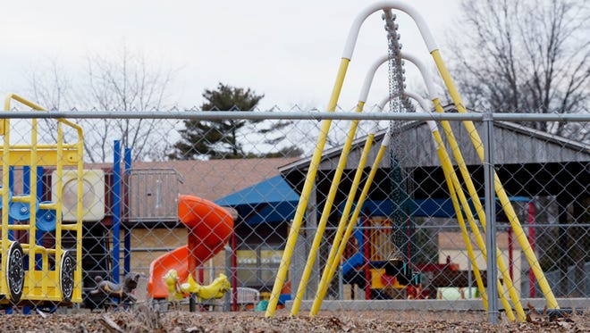 FILE - In this Jan. 26, 2016 file photo, the empty playground at Trinity Lutheran Church in Columbia, Mo. The Supreme Court has ruled that churches have the same right as other charitable groups to seek state money for new playground surfaces and other non-religious needs. The justices on Monday, June 26, 2017, ruled 7-2 in favor of Trinity Lutheran Church of Columbia, Missouri. The church sought a grant to put a soft surface on its preschool playground, but was denied any money even though its application was ranked fifth out of 44 submissions (Annaliese Nurnberg/Missourian via AP, File)