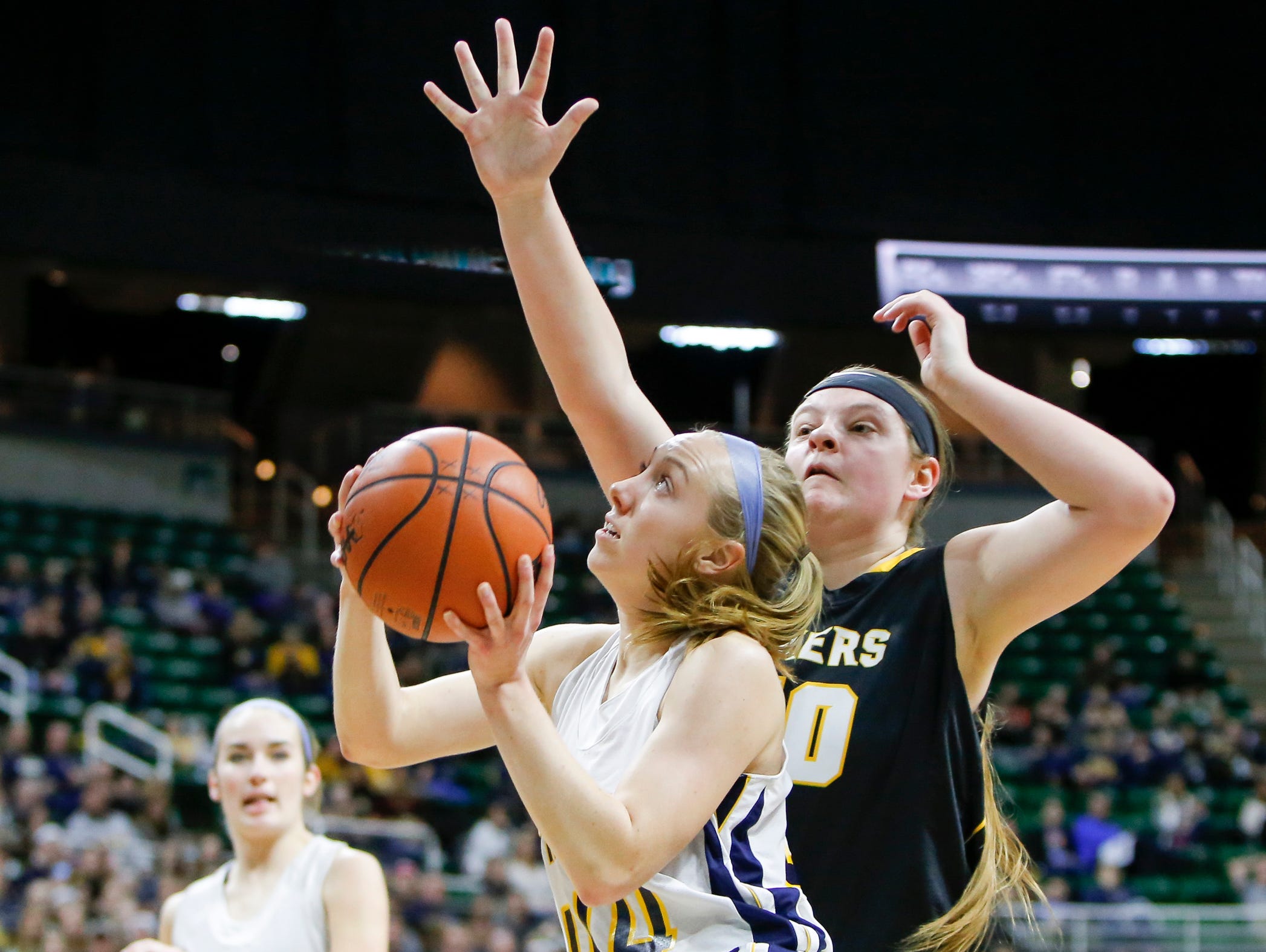 P-W's Brenna Wirth draws a foul against Maple City Glen Lake's Kaitlyn Schaub Thursday, March 16, 2017, during the Class B Semifinal at the Breslin in East Lansing. P-W won 64-51.