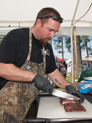 George Przybylski, of Wilmington, with Bang Bang BBQ prepares ribs for judging at the Triple Threat BBQ, Beer & Music Festival at the Delaware State Fair Grounds on Saturday.