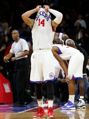 76er K.J. McDaniels hides in his jersey Nov. 26 during a loss against the Brooklyn Nets.