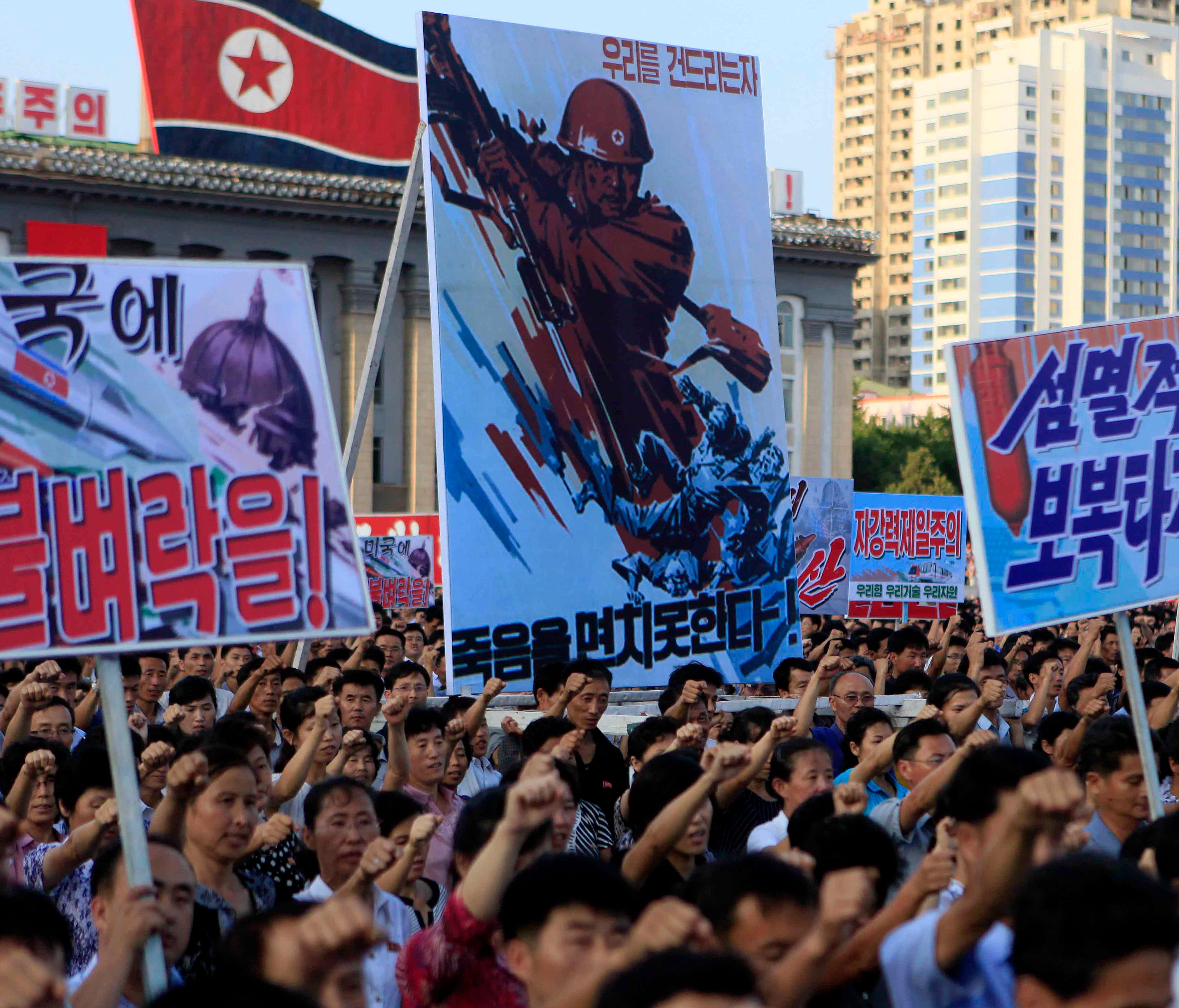Tens of thousands of North Koreans gathered for a rally at Kim Il Sung Square carrying placards and propaganda slogans as a show of support for their rejection of the United Nations' latest round of sanctions on Wednesday Aug. 9, 2017, in Pyongyang, 