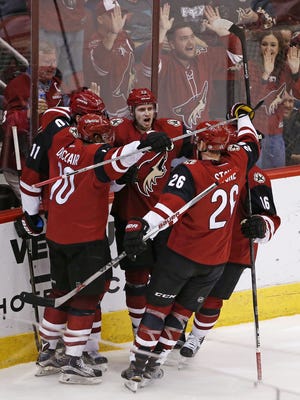 Arizona Coyotes celebrate a goal by Michael Stone (26) against the Dallas Stars in the 2nd period in Glendale, Ariz., on Thursday, February 18, 2016.