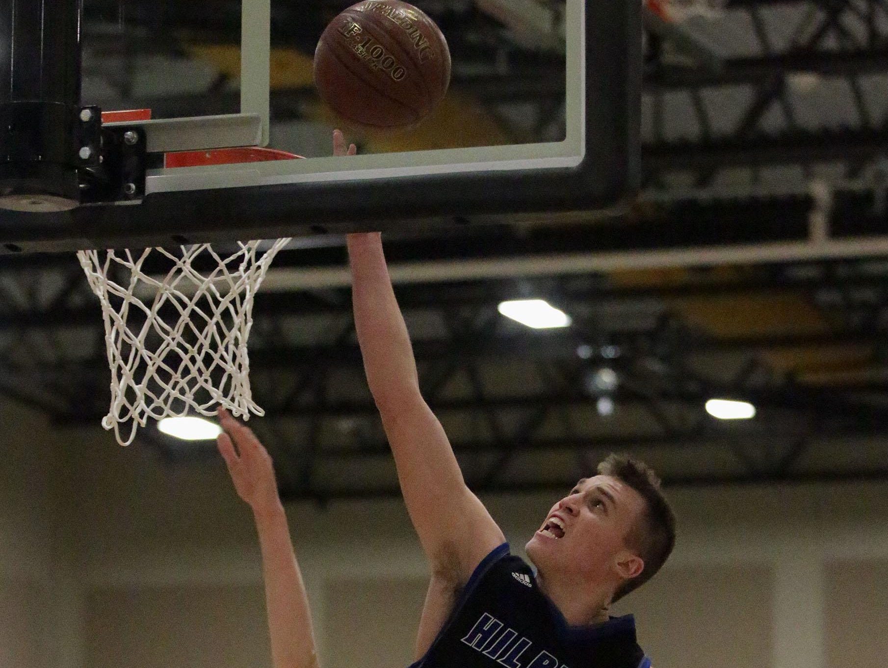 Hilbert’s Jack Halbach puts up a shot against Sheboygan Christian on Thursday in Brown Deer.