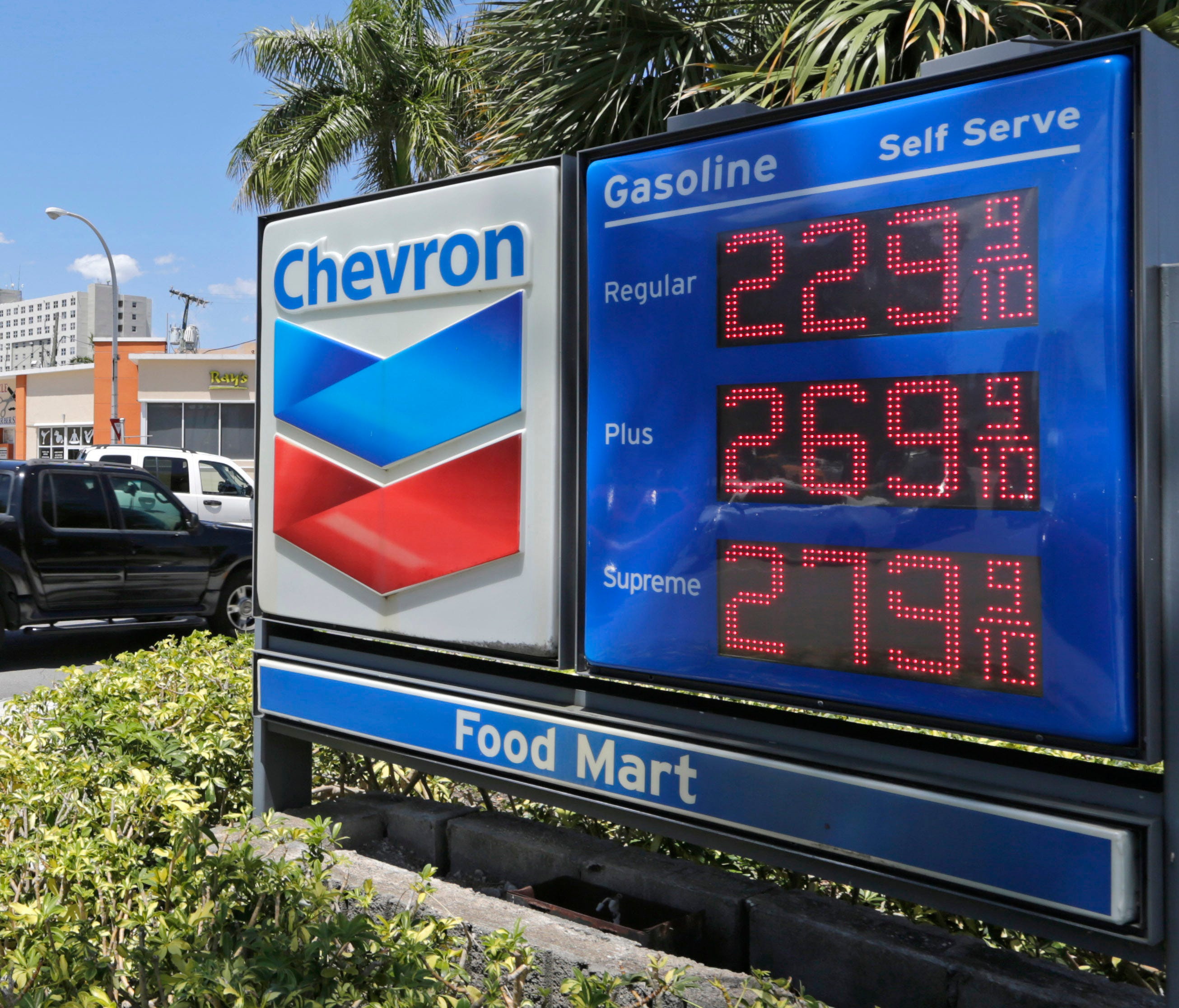In this Monday, May 15, 2017, photo, motorists pass a Chevron sign listing gas prices, in Miami Springs, Fla. On Friday, July 14, 2017, the  Labor Department reports on U.S. consumer prices for June.