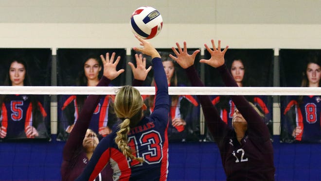 Veterans Memorial's Jordan Wonders taps the ball over Calallen defenders earlier this season. Both teams will open the Class 5A playoffs on Tuesday.