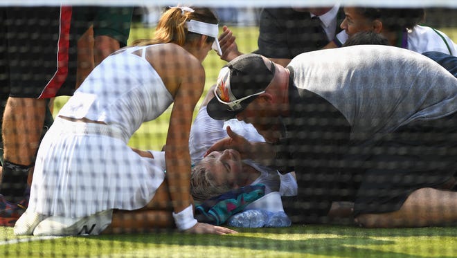 Bethanie Mattek-Sands of The United States receives treatment from the medical team and later retires from the Ladies Singles second round match against Sorana Cirstea of Romania on day four of the Wimbledon Lawn Tennis Championships at the All England Lawn Tennis and Croquet Club on July 6, 2017 in London, England.