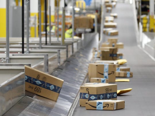 In this December 2019 file photo, Amazon packages move along a conveyor at an Amazon warehouse facility in Goodyear, Arizona. An Amazon delivery station is expected to open in Gainesville at 2121 NW 67th Place by the end of 2020.