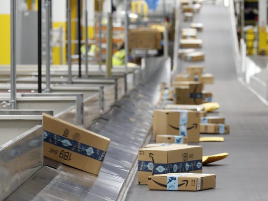 In this December 2019 file photo, Amazon packages move along a conveyor at an Amazon warehouse facility in Goodyear, Arizona. An Amazon delivery station is expected to open in Gainesville at 2121 NW 67th Place by the end of 2020.