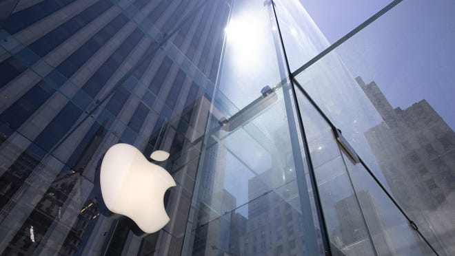 FILE - In this June 16, 2020 file photo, the sun is reflected on Apple's Fifth Avenue store in New York. Apple is the first U.S. company to boast a market value of $2 trillion, just two years after it became the first to reach $1 trillion. Apple shares have gained nearly 60% this year as the company overcame the shutdown of factories in China that produce the iPhone and the closure of its retail sales amid the coronavirus pandemic. (AP Photo/Mark Lennihan, File)