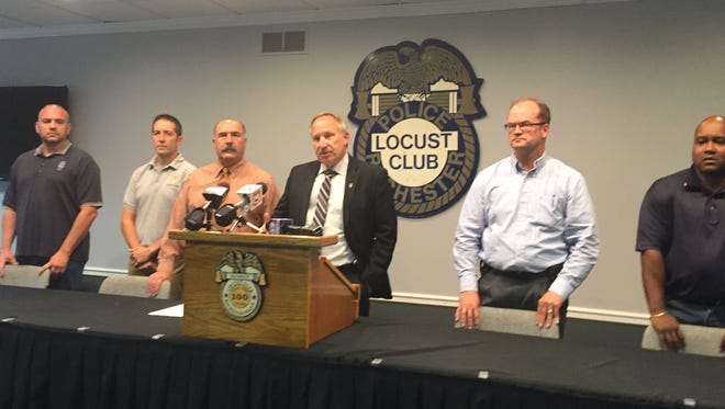 Locust Club president Mike Mazzeo, center,  discusses reaction to cellphone video of an arrest and his concerns about the city's body camera program.