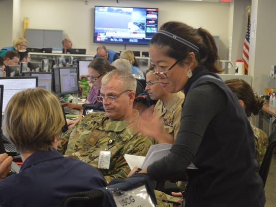 Workers at FEMA's emergency command center from all