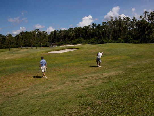 Golfers Jack Tilson and Tom Taggart play the 13th hole