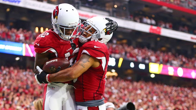 Arizona Cardinals wide receiver John Brown (left) celebrates with Michael Floyd after catching a first quarter touchdown pass against the New Orleans Saints at University of Phoenix Stadium.