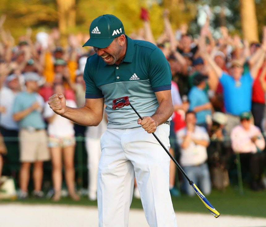 Sergio Garcia celebrates after making a putt on the 18th green during the first playoff hole to win The Masters.