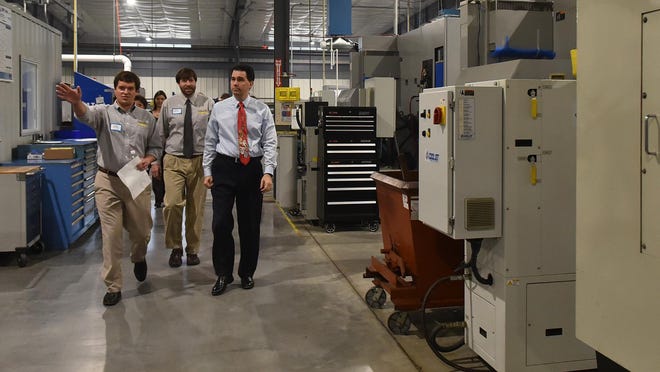 Gov. Scott Walker tours newly expanded Pro Products, Inc., 1450 S. Neenah Ave., Sturgeon Bay, with Steven Hurley, vice president of operations, left, and Jon Hurley, vice president of sales and purchasing. Following the tour Friday, the governor spoke to invited guests about the growth of the economy and manufacturing.