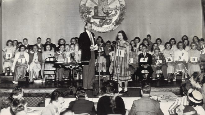 Diana Hull of Akron, Ohio, steps to the microphone to open the 22nd annual National Spelling Bee in 1949.