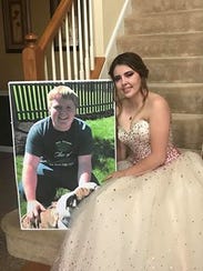 Kaylee Sudders holds a photo of Carter Brown, her boyfriend and 2017 graduate of James Buchanan High School who was killed in a car crash in April in Huntingdon. Because Carter is not here, his dad, Robert Brown, escorted Kaylee to JB's prom, on Saturday, May 19, 2018, at Green Grove Gardens, Greencastle.