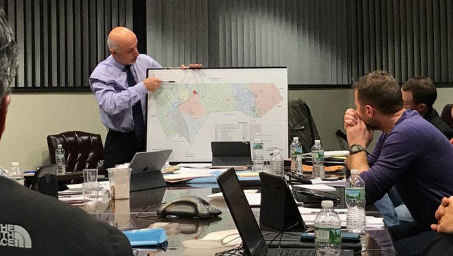 Mayor Mike Ghassali points to a map of the proposed eruv that would enter Montvale from New York State.
