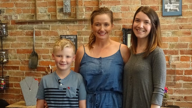 Braave co-founder Shawnda McNeal (center) her son (left), and Braave director Katelyn Anderson stand inside the organization's headquarters in Chillicothe.
