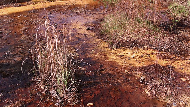 Acid mine drainage polluted water seeping from an abandoned mine in eastern Kentucky in early 2000s.