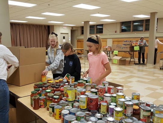 Tosa Cares volunteers start sorting food donated from
