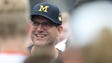 Michigan coach Jim Harbaugh talks to high school players