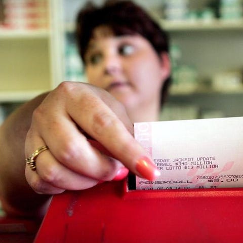  Maryanne Rearick rings up Powerball lottery ticke