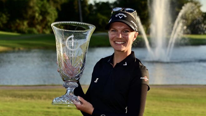 Madelene Sagstrom holds the winning trophy Sunday after finishing first at the Gainbridge LPGA tournament at Boca Rio.