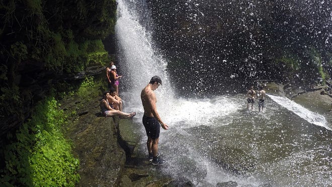 Cummins Falls outside of Cookeville in Jackson County is an ideal place to cool off from the summer heat. People cool off in the waterfall at Cummins Falls State Park on Tuesday, June 28, 2016.