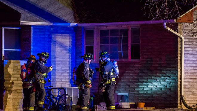 Firefighters clear up the scene of a structure fire on the South-West corner of West Mulberry Street and South Grant Avenue, Saturday night, Nov. 18, 2017, in Fort Collins, Colo.