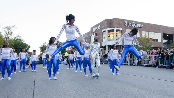 The Dream Center's Dream Divas dance their way down the parade route during the University of Iowa Homecoming parade Friday, Oct. 9, 2015.