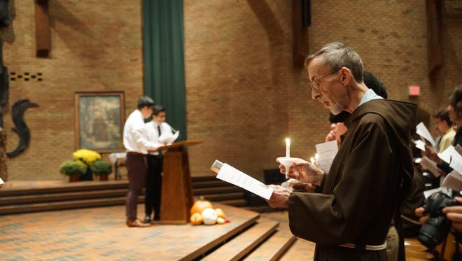 Capuchin Franciscan followers of St. Francis held lit candles during the service Oct. 3 celebrating the Transitus of St. Francis of Assisi.