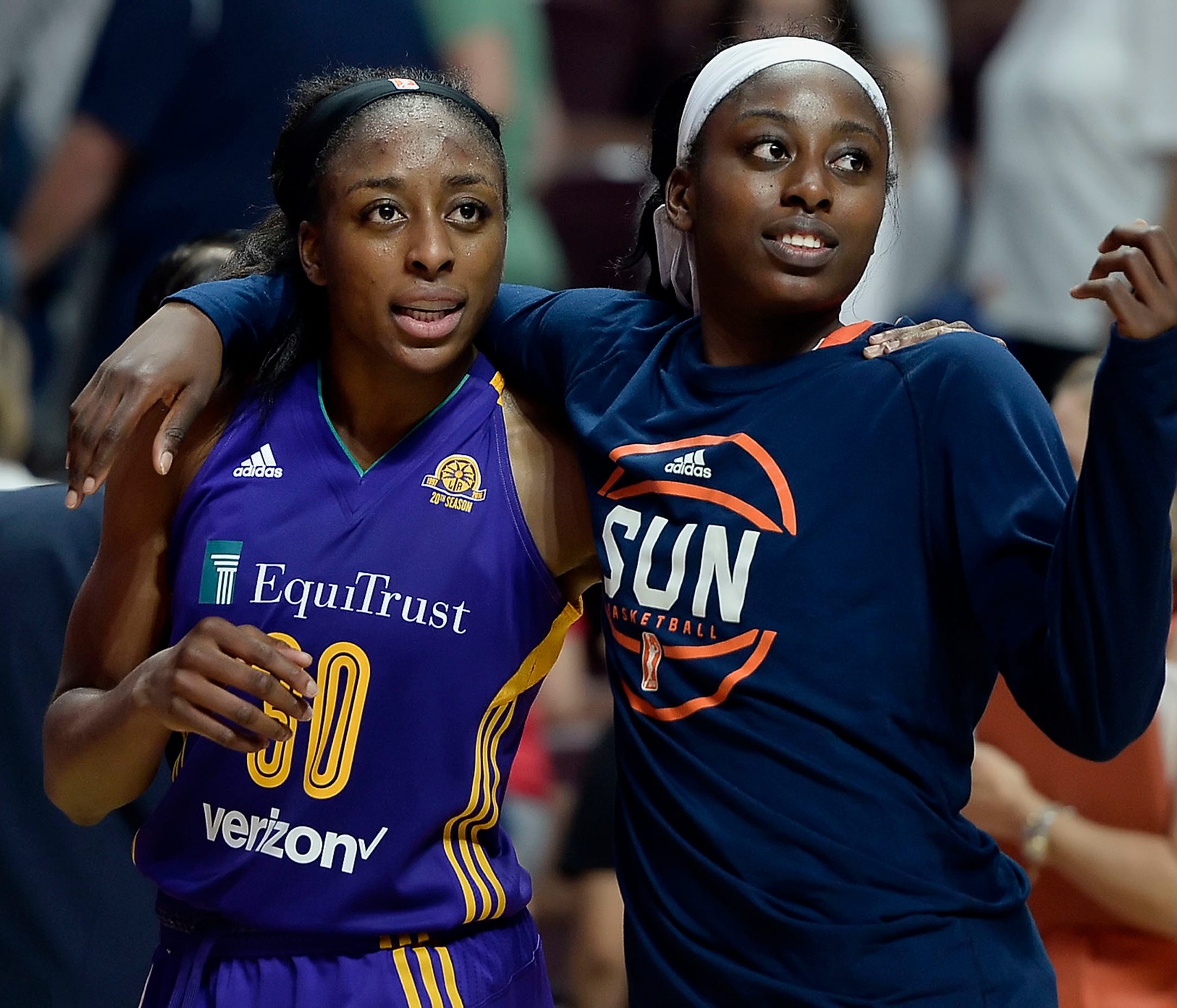 FILE - In this May 26, 2016, file photo, sisters Los Angeles Sparks' Nneka Ogwumike, left, and Connecticut Sun's Chiney Ogwumike, right, walk off the court together at the end of a WNBA basketball game between the their teams, in Uncasville, Conn. Ch