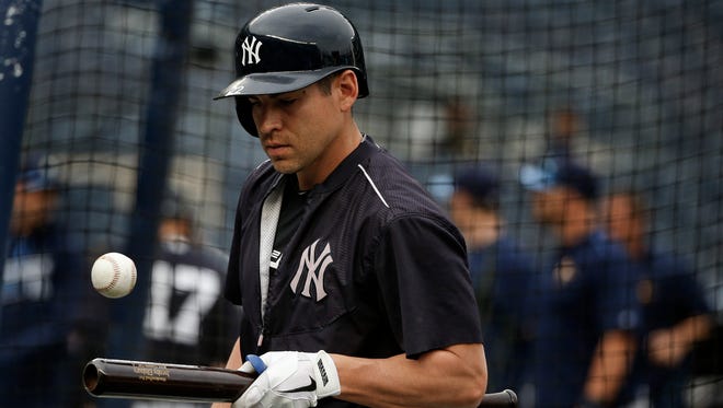 New York Yankees center fielder Jacoby Ellsbury (22) plays with a ball on his bat during batting practice before playing in a baseball game against the Tampa Bay Rays, Friday, April 22, 2016, in New York.