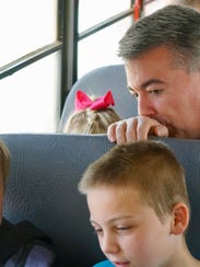 Colorado Sen. Cory Gardner watches as students in rural Eastern Colorado use their new Google-issued Chromebooks to work on a Wi-Fi enabled school bus in April 2017. Gardner, an ardent defender of states' rights, says he's secured a promise from President Trump to leave Colorado's legal marijuana industry alone. Colorado voters who approved legalizing cannabis also mandated that millions of dollars in marijuana taxes help fund construction in rural school districts.