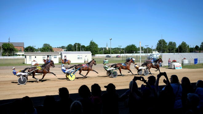 Spectators watch the final race during the remembering Jackson Harness Raceway races, Sunday, July 8, 2018, at the Jackson County Fairgrounds in Jackson, Mich.  The raceway, which opened in 1948, will be demolished after next month's county fair.