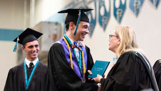 Senior Class President Courtland Campo receives his diploma from Martin County School District Superintendent Laurie Gaylord during the Jensen Beach High School Class of 2018 commencement ceremony on Monday, May 21, 2018, at Jensen Beach High School in Jensen Beach. The school district will receive more recognition funds this year compared to previous years.