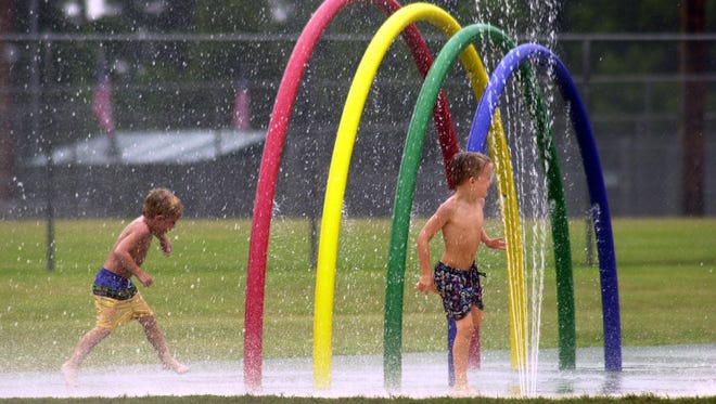    Thu, 12 Jul 01 (ddwet2)  DIGITAL IMAGE by Dave Darnell.  Kids play in the water spray park at W.C. Johnson Park in Collierville between thunderstorms.